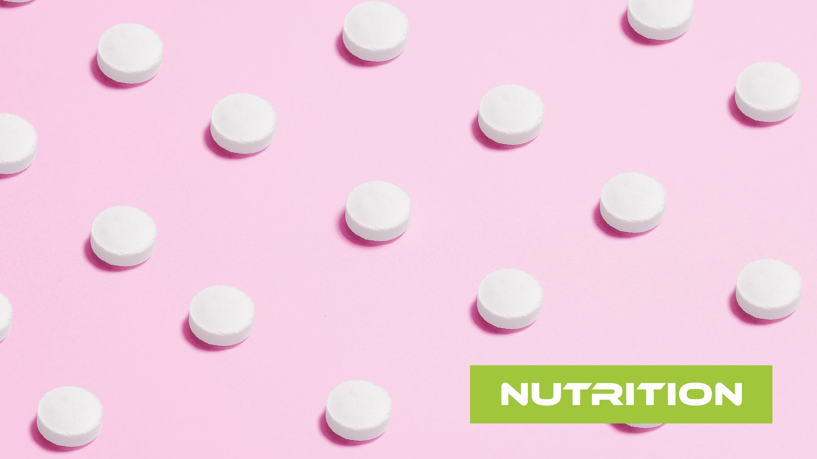 White sweetener tablets on a pink background
