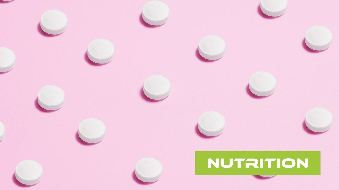 White sweetener tablets on a pink background